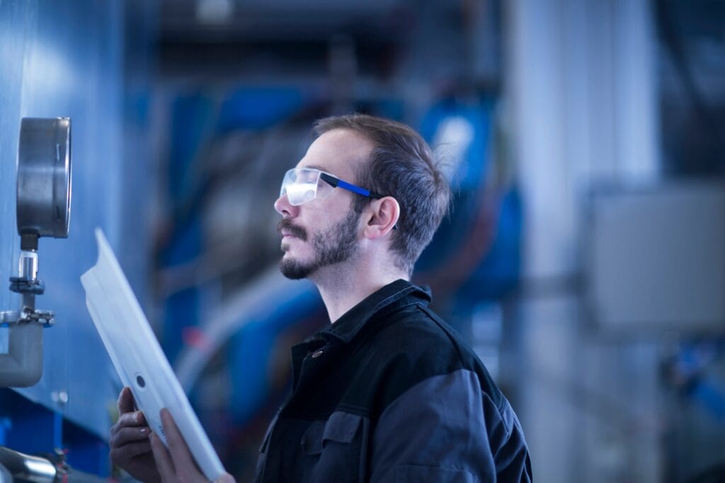 Engineer checking pressure gauge